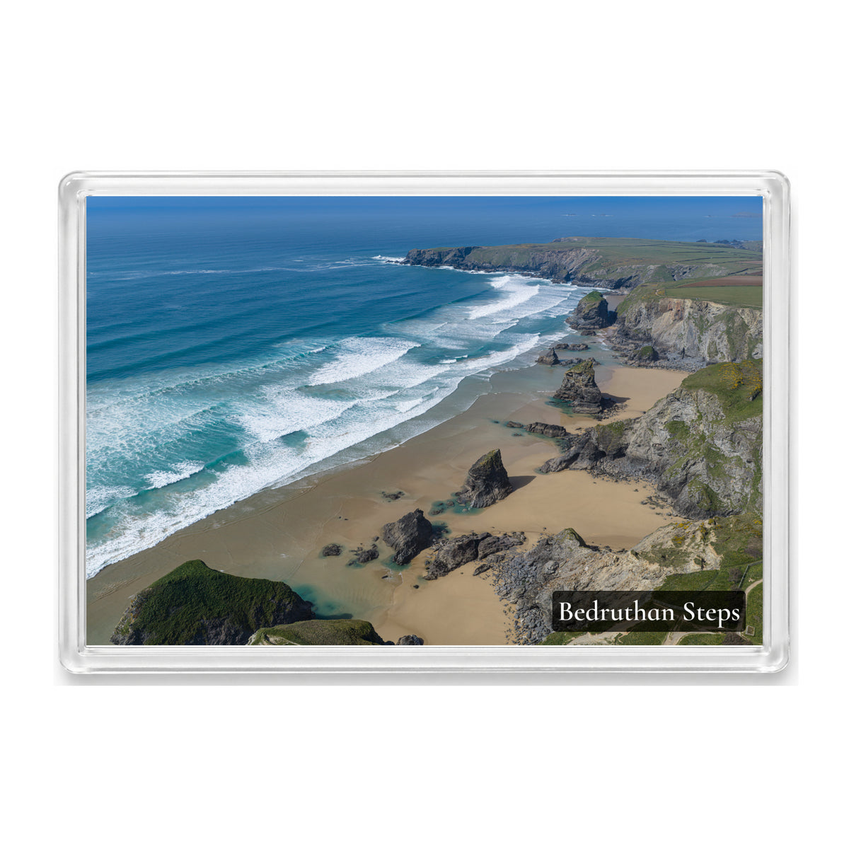 Bedruthan Steps fridge magnet showing the sea stacks at peak low tide surrounded by sand, with lines of swell beyond