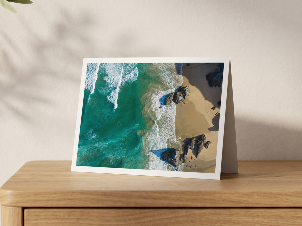 Premium A5 greeting card showing a top-down view of waves, sand and rocks on the shore near Bedruthan Steps