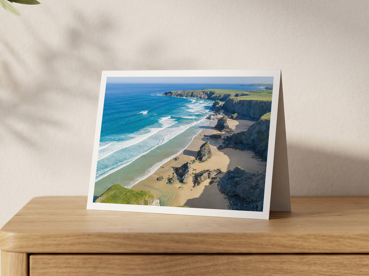 Premium A5 greeting card showing Bedruthan Steps at low tide with turquoise surf and Trevose Head in the distance