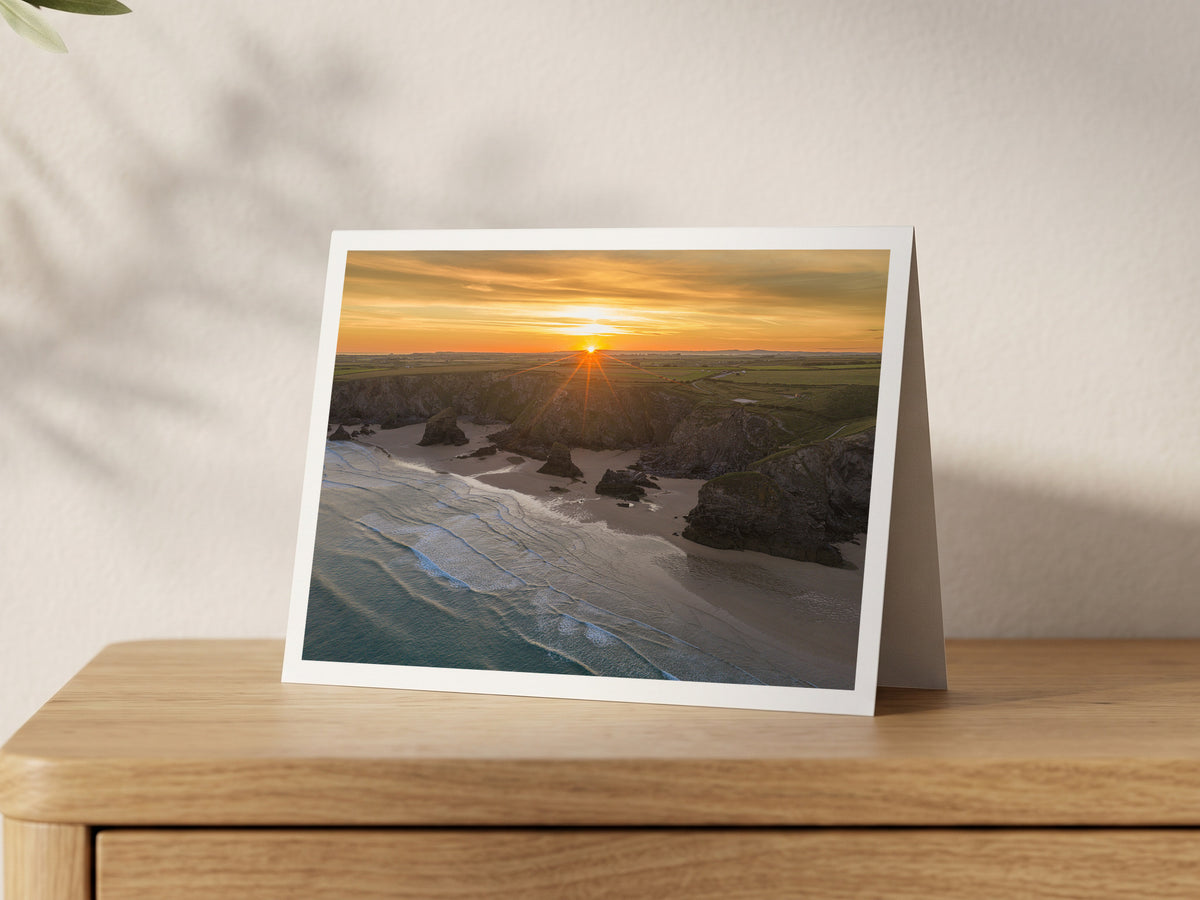 Premium A5 greeting card showing sunrise over the cliffs and sea stacks of Bedruthan Steps at low tide