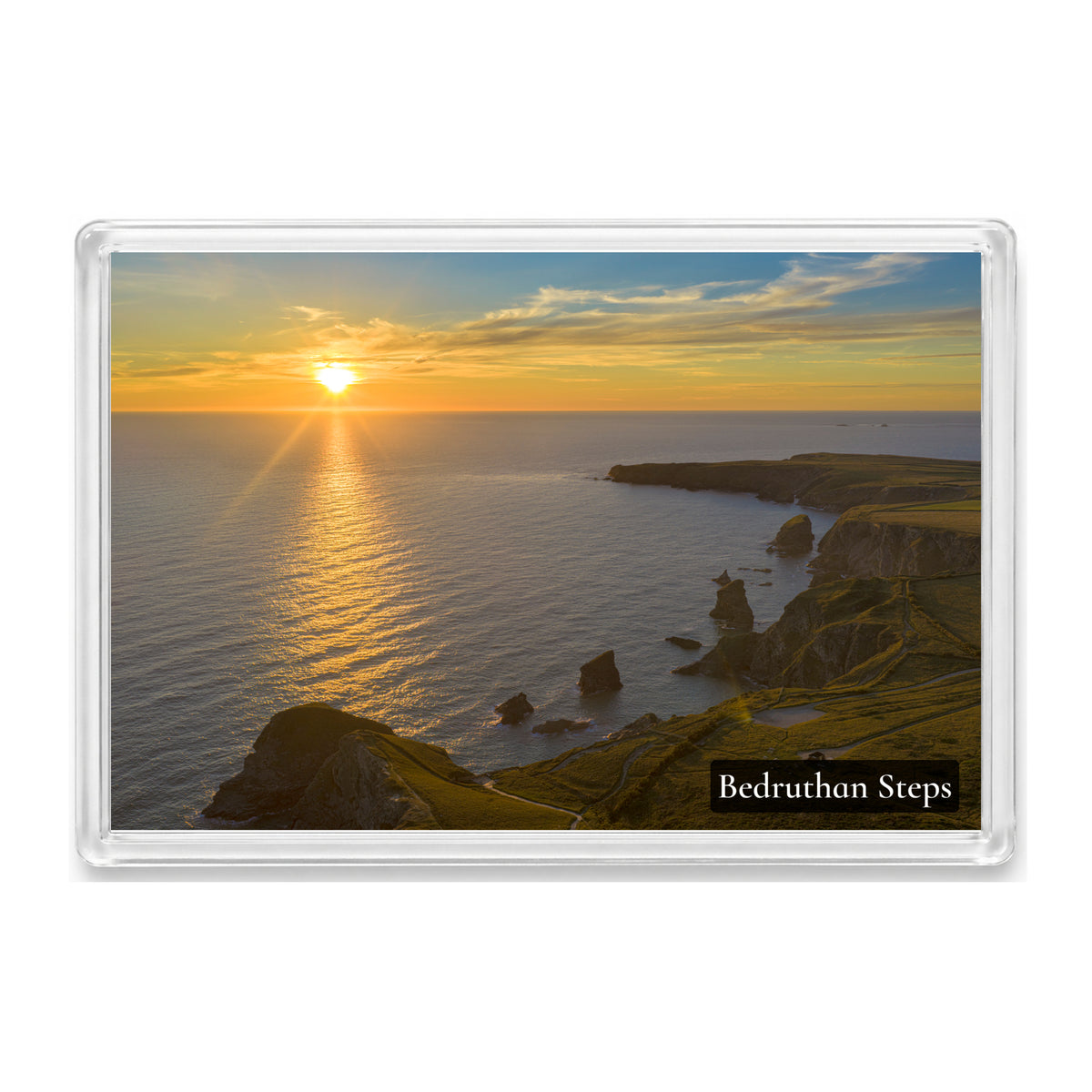Bedruthan Steps fridge magnet showing the sea stacks at high tide with an orange and yellow sunset gleaming across the water