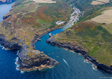 Aerial view of Boscastle harbour inlet, kayaks and village on the North Cornwall coast