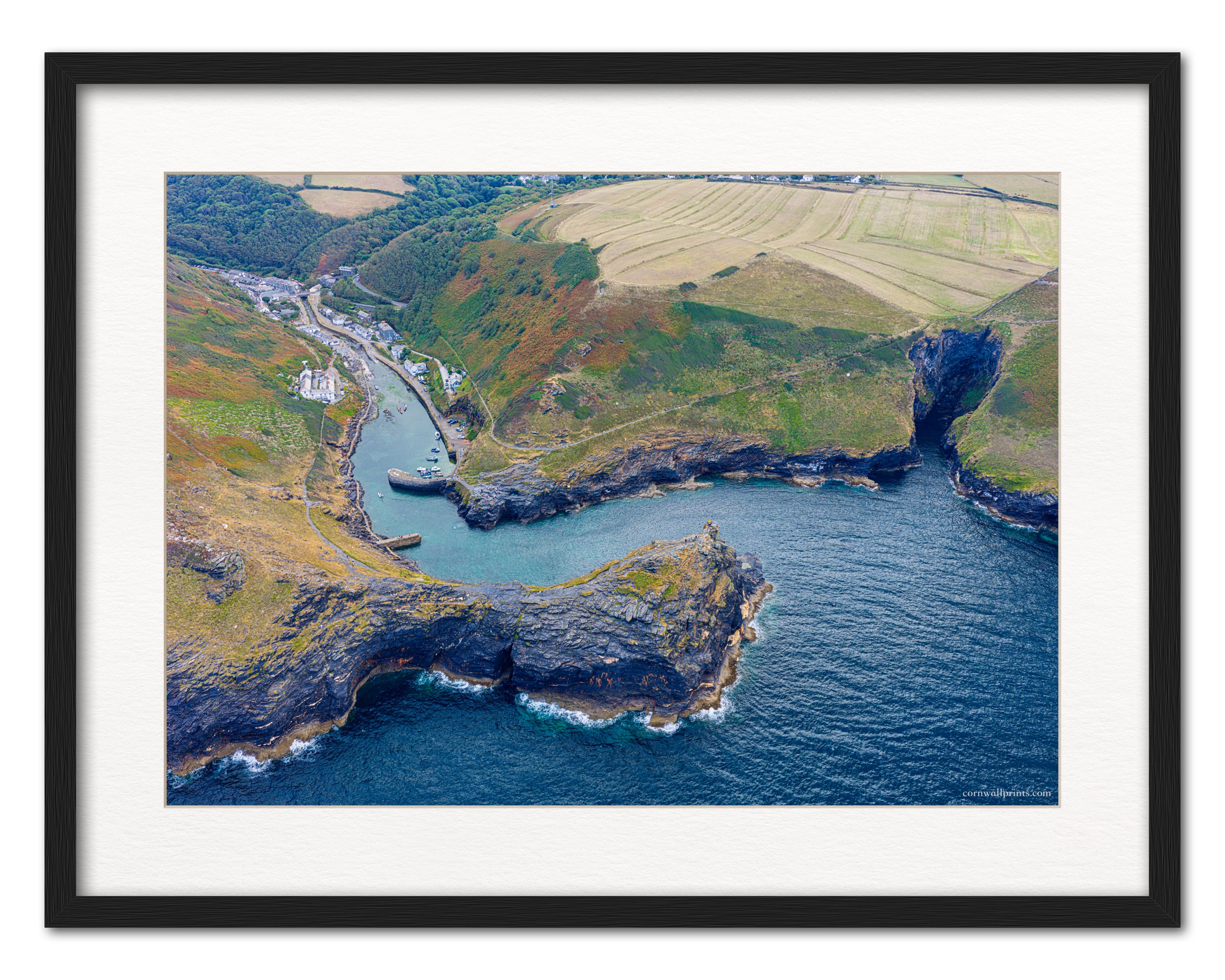 Boscastle harbour entrance aerial photograph displayed in a black frame with white mount