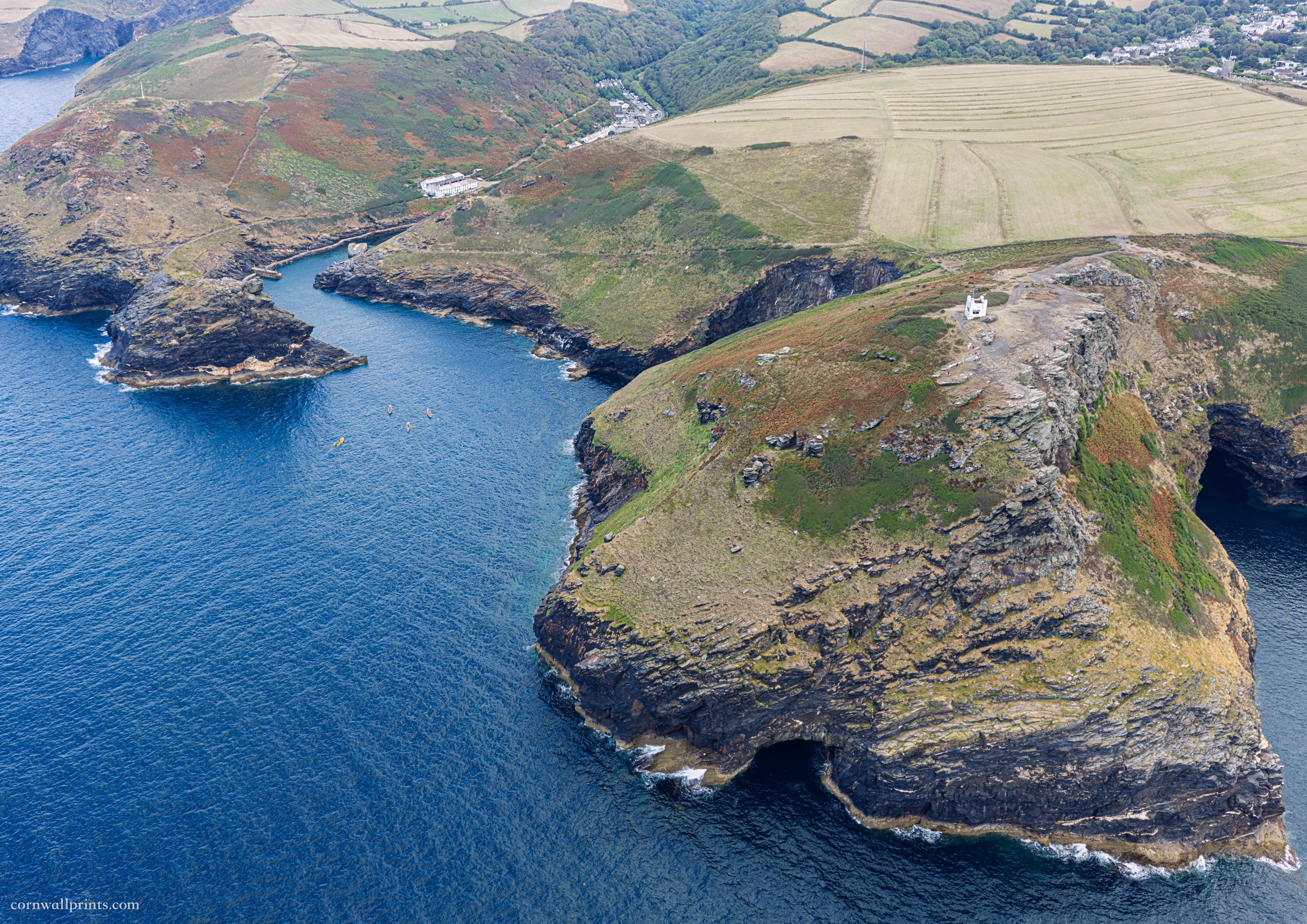 Aerial view from sea across Willapark headland, NCI Boscastle lookout, harbour entrance and Forrabury Stitches