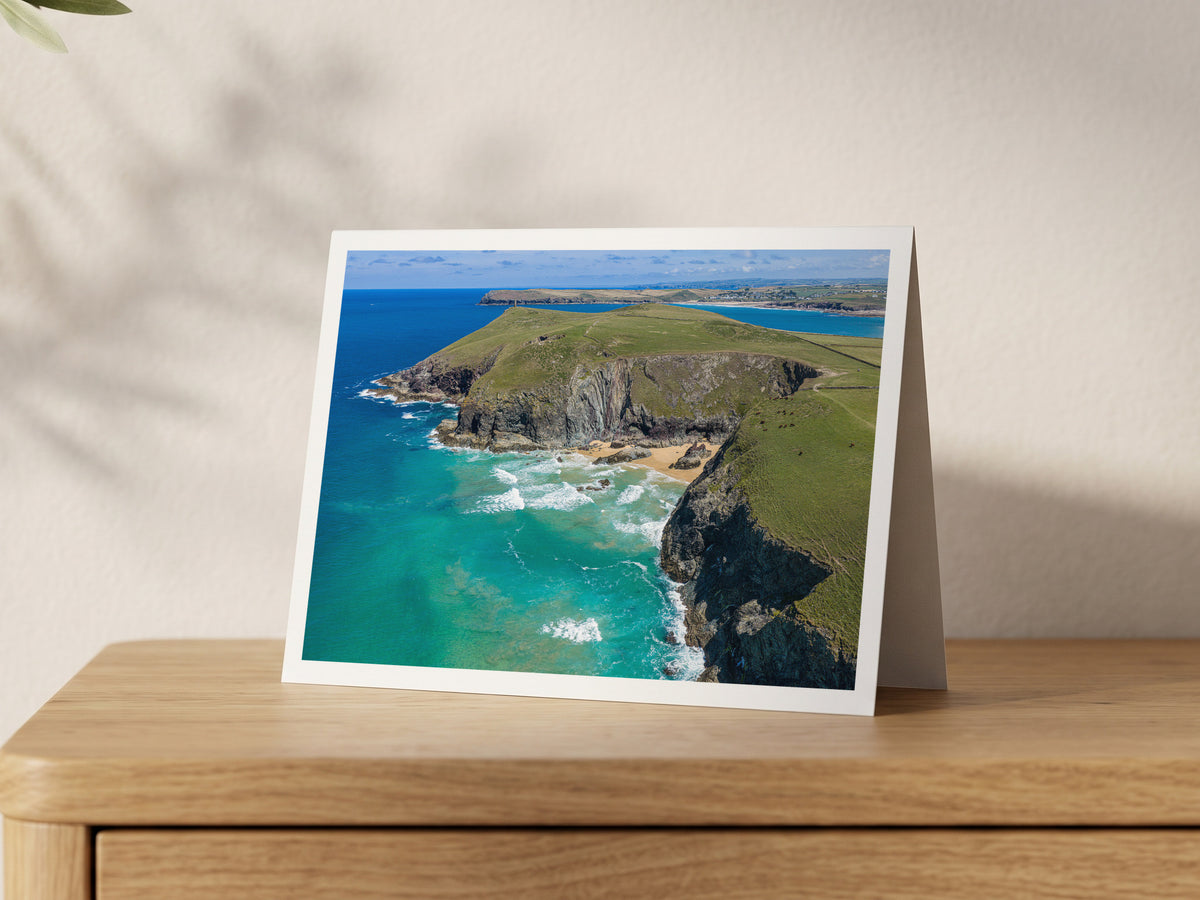 Premium A5 greeting card showing the hidden cove of Butterhole Beach below green cliffs, with turquoise water and Stepper Point