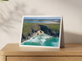 Premium A5 greeting card showing the cliff-enclosed cove of Butterhole Beach with surf and the Camel Estuary beyond