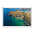 Butterhole Beach fridge magnet showing the secluded sand and jagged cliffs below the Stepper Point daymark with Polzeath across the water