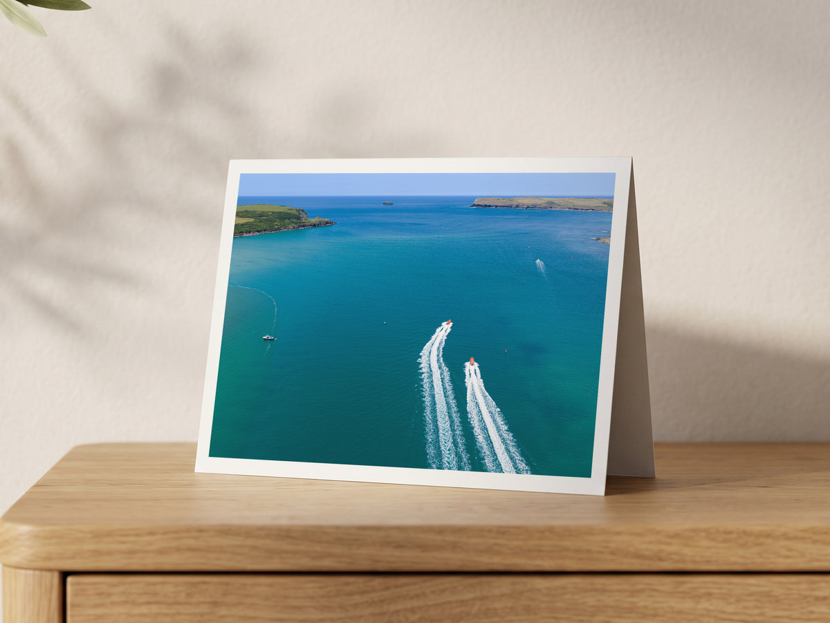 Premium A5 greeting card showing two boats leaving white wakes across blue water at the mouth of the Camel Estuary