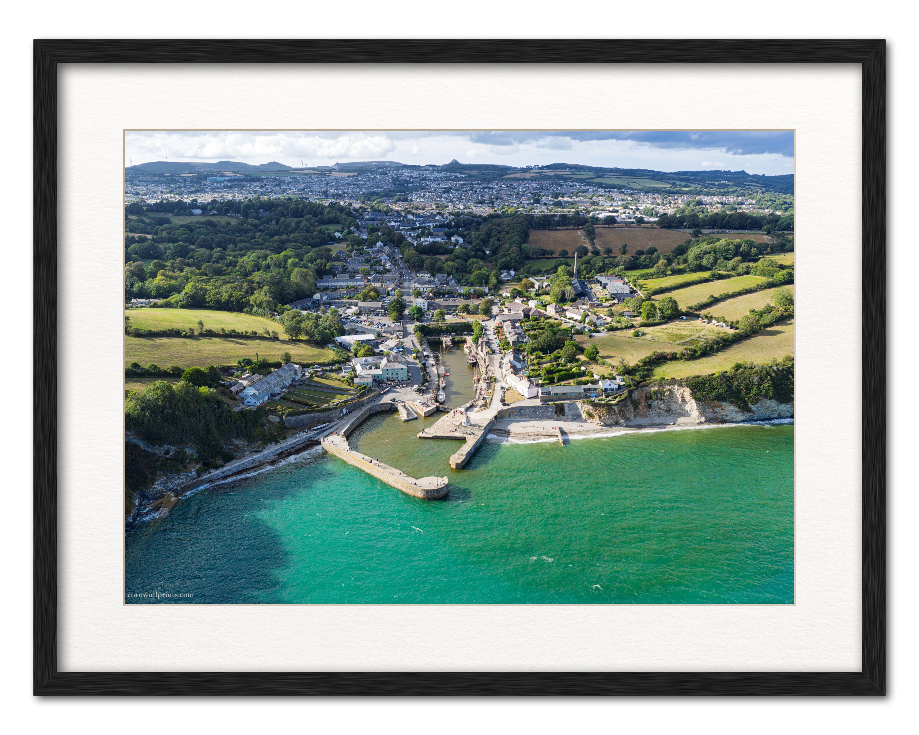 Charlestown Harbour aerial photograph looking towards St Austell and the Sky Tip, displayed in a black frame with white mount