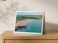 Premium A5 greeting card showing the curve of Constantine Bay in autumn daylight, with Treyarnon in the distance