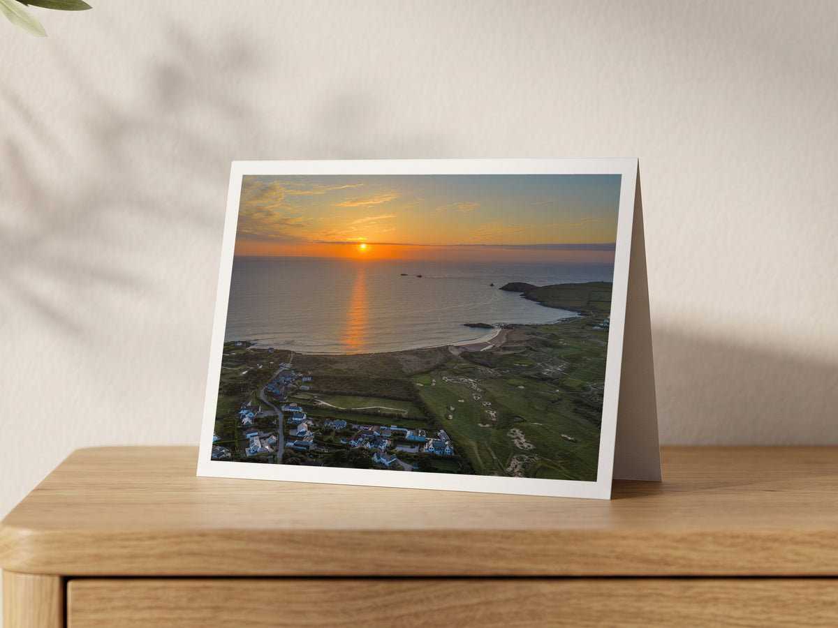Premium A5 greeting card showing the sun setting over a flat calm Constantine Bay at high tide