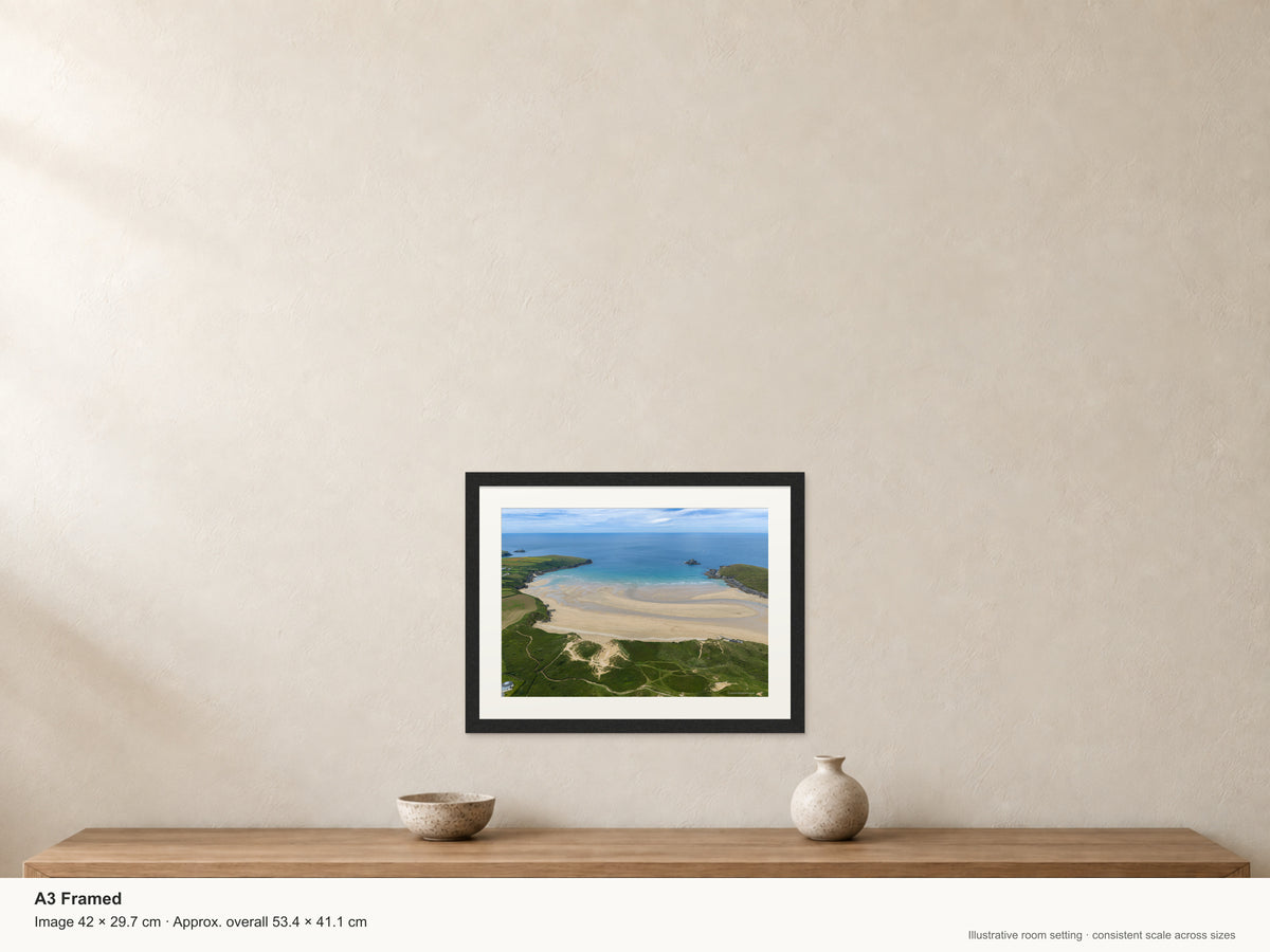 Framed Crantock Bay print shown to illustrate its size