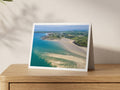 Premium A5 greeting card showing the Doom Bar sandbar at low tide with Polzeath beyond