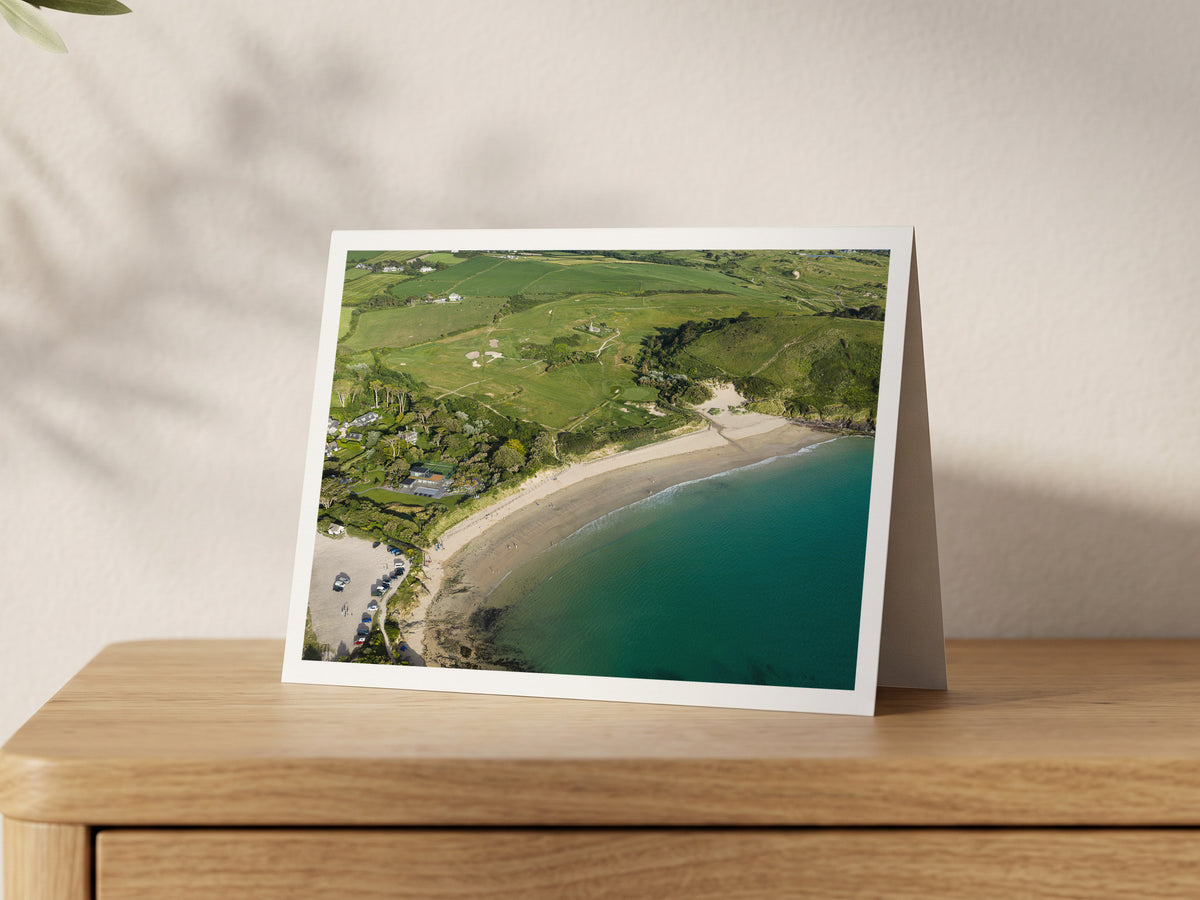 Premium A5 greeting card showing Daymer Bay at high tide with St Enodoc Church above the dunes