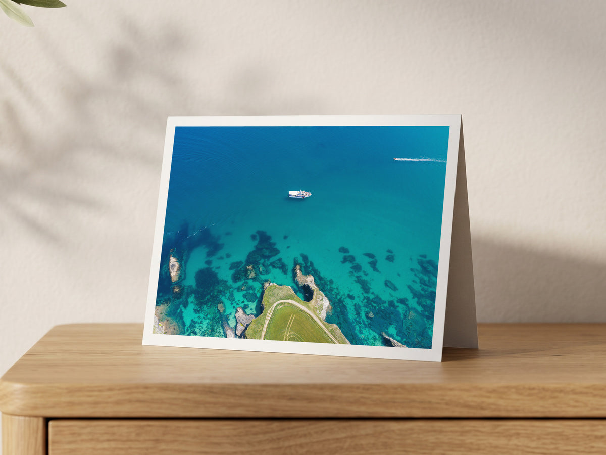 Premium A5 greeting card showing a small ferry crossing clear turquoise water off Harlyn