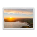 Harlyn Bay fridge magnet showing a yellow winter sunrise sending rays across the shoreline and calm morning water
