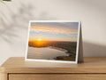 Premium A5 greeting card showing a winter sunrise with sunrays over Harlyn Bay