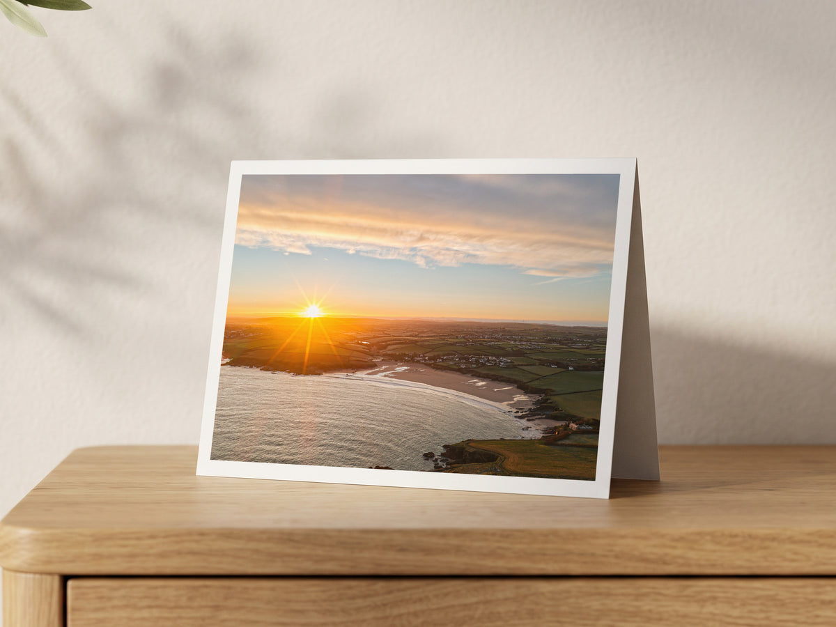 Premium A5 greeting card showing a winter sunrise with sunrays over Harlyn Bay