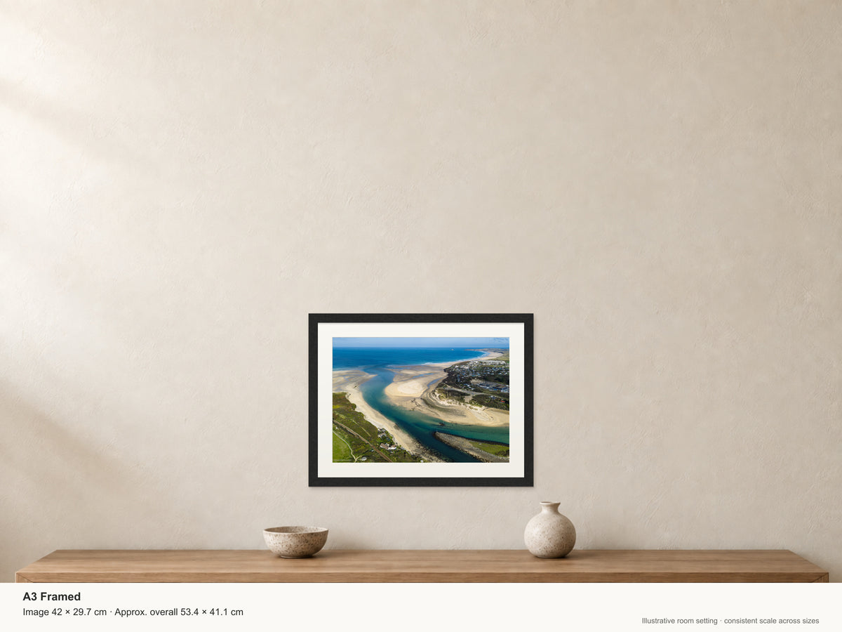 Turquoise Hayle Estuary channels and textured pale sandbanks, viewed from the Porthkidney side towards Gwithian and distant Godrevy Lighthouse — A3 22mm black stained frame and 35mm mount. Illustrative room view with dimensions.