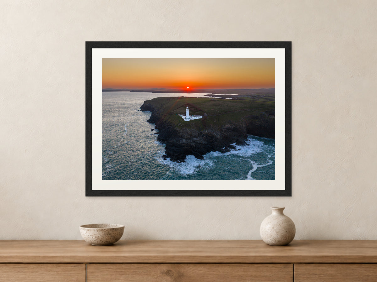 Trevose Head lighthouse at sunrise in a black frame