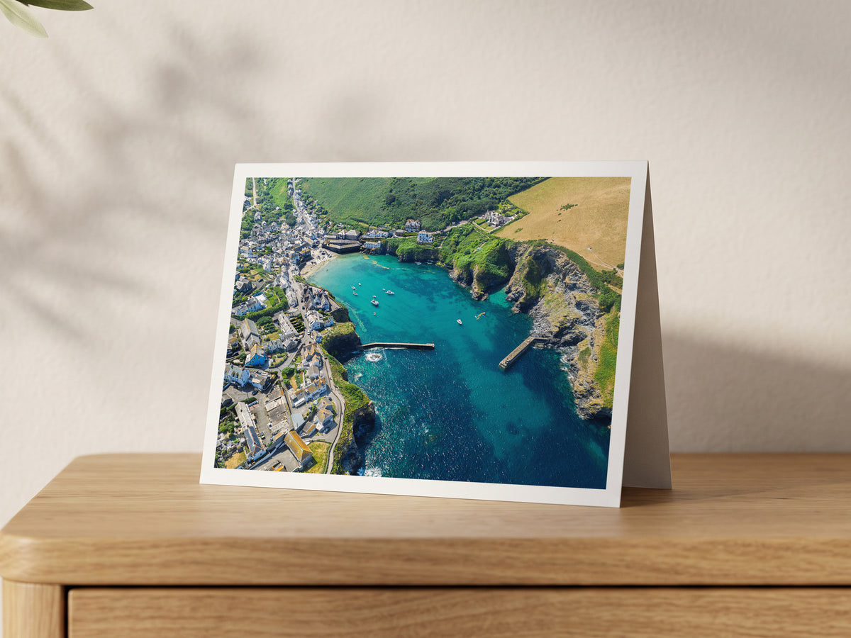 Premium A5 greeting card showing Port Isaac harbour at high tide with moored boats and village rooftops