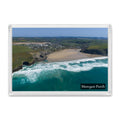 Mawgan Porth fridge magnet showing the wide low-tide beach and village from the sea, framed by grassy cliffs