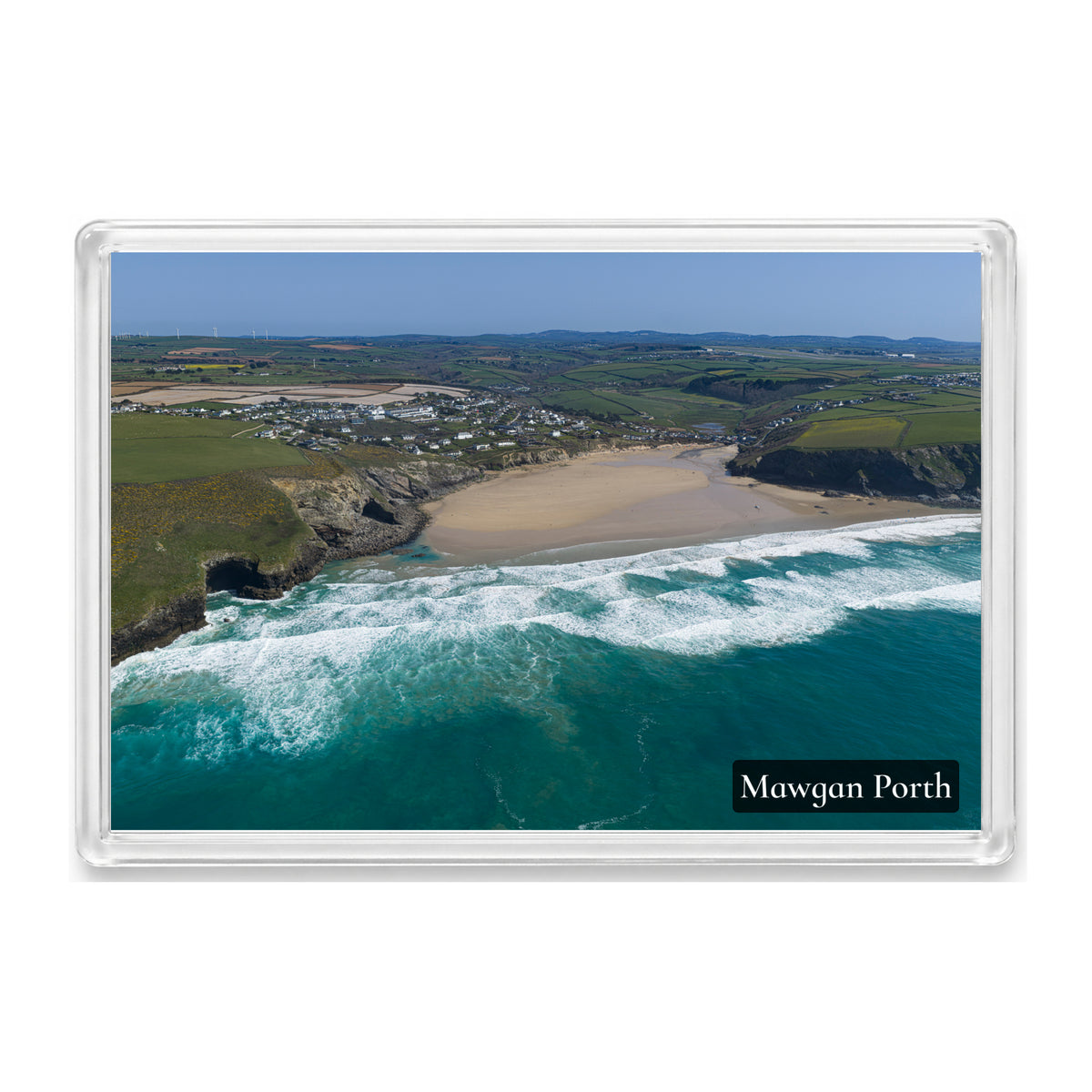 Mawgan Porth fridge magnet showing the wide low-tide beach and village from the sea, framed by grassy cliffs