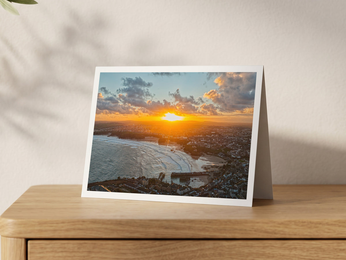 Premium A5 greeting card showing sunrise over Newquay town, harbour and beaches