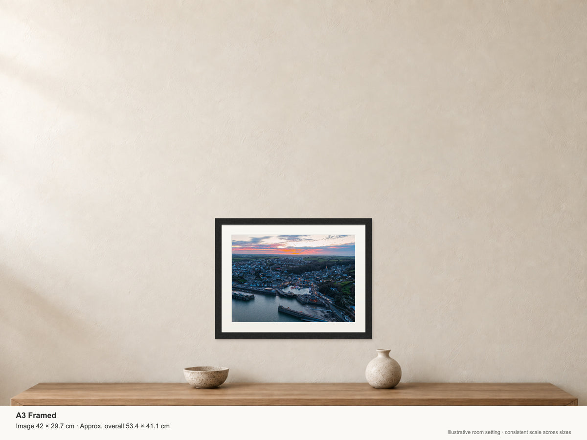 Christmas Dusk Over Padstow Harbour — A3 framed, 22mm black stained frame and 35mm mount. Illustrative room view and dimensions.