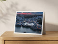 Premium A5 greeting card showing Padstow Harbour head-on at dusk with festive lights on the water
