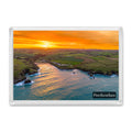 Porthcothan Bay fridge magnet showing orange and red autumn sunrise light over the dune-backed cove, fields and water