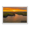 Porthcothan Bay fridge magnet showing a golden sunrise path across the water into the bay, with dark headlands and the village beyond