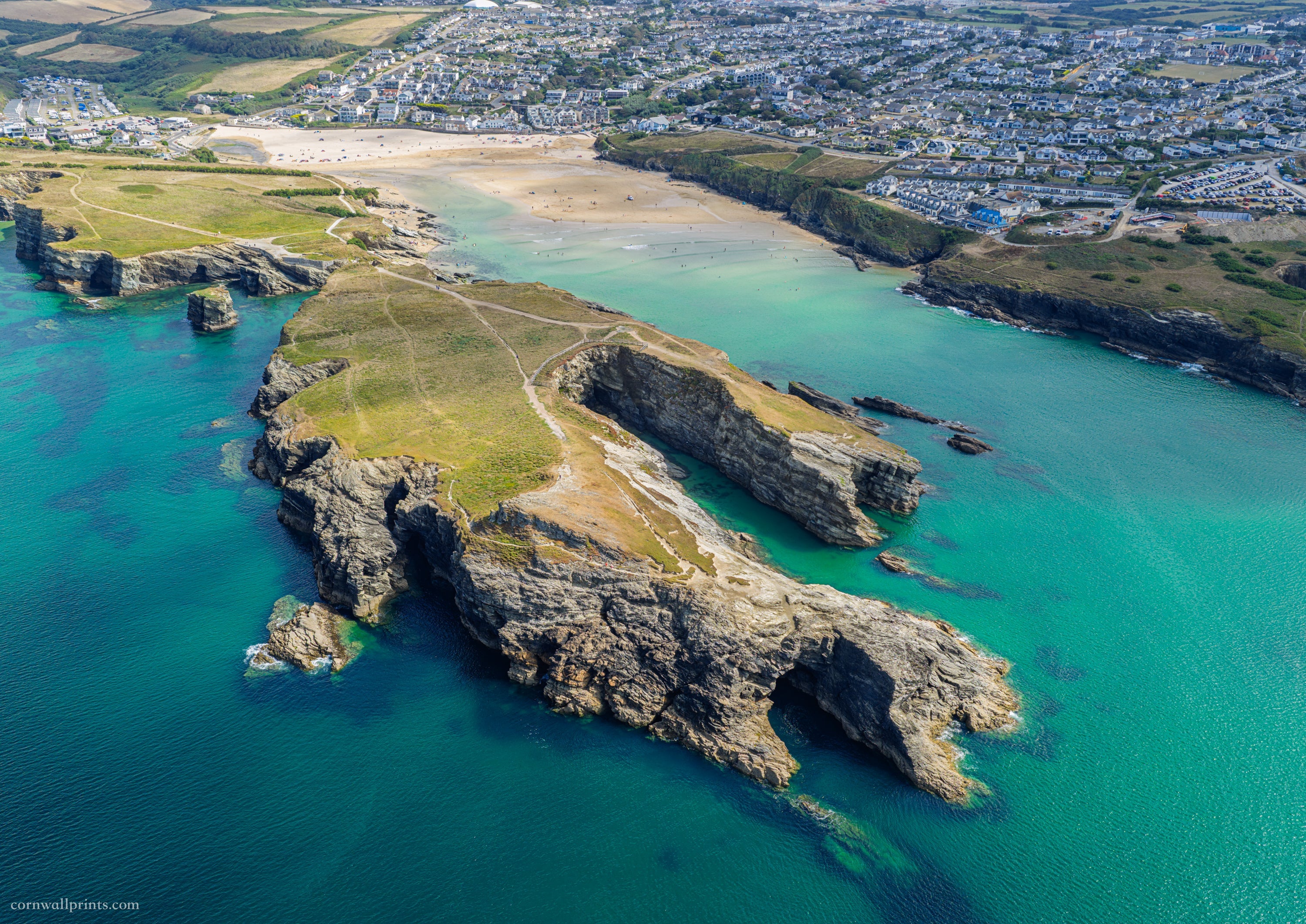 Aerial view over Porth Island, turquoise water and Porth Beach in Newquay