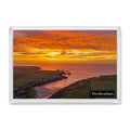 Porthcothan sunset in orange and gold over the bay and beach, with a Porthcothan label, inside a clear acrylic fridge magnet.