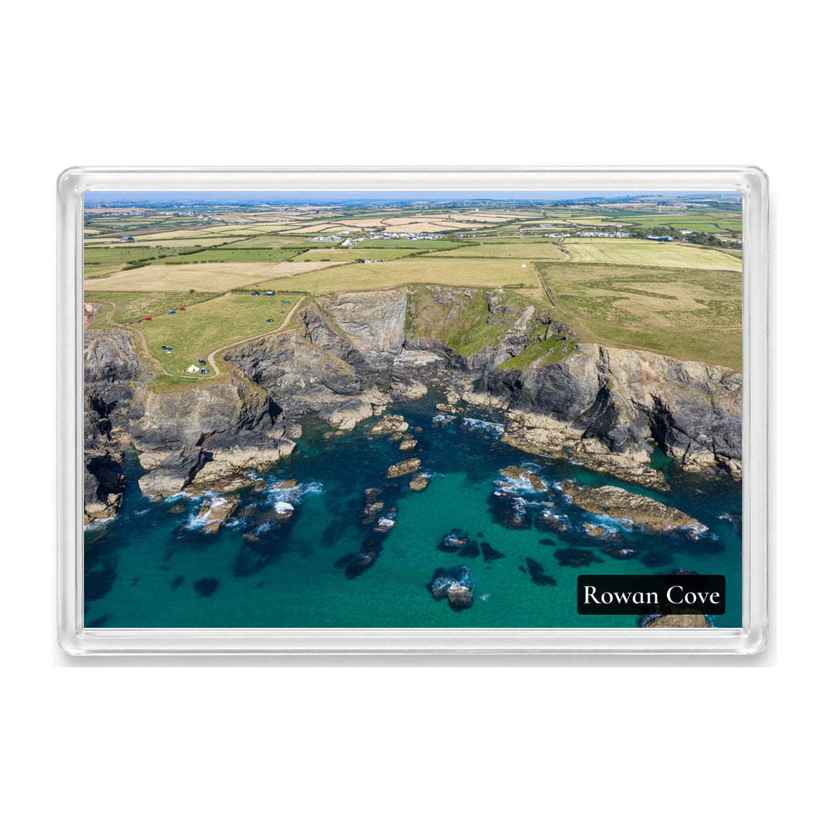Rowan Cove fridge magnet showing light blue, clear shallows along the low-tide shoreline of the small cove