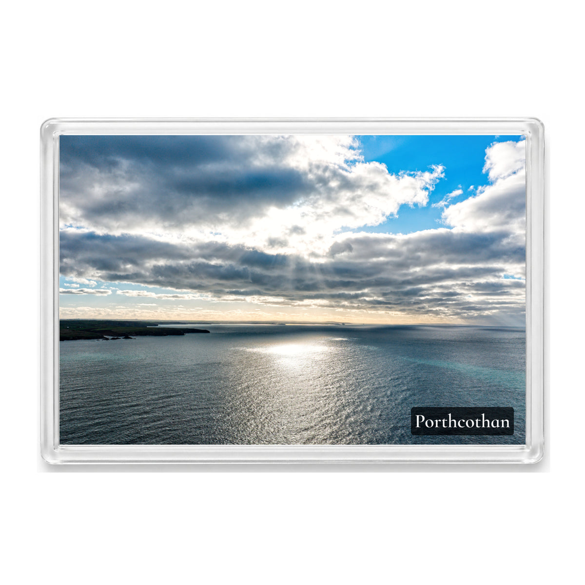 Porthcothan fridge magnet showing sunlight breaking through cloud onto the Atlantic, looking along the coast towards Newquay
