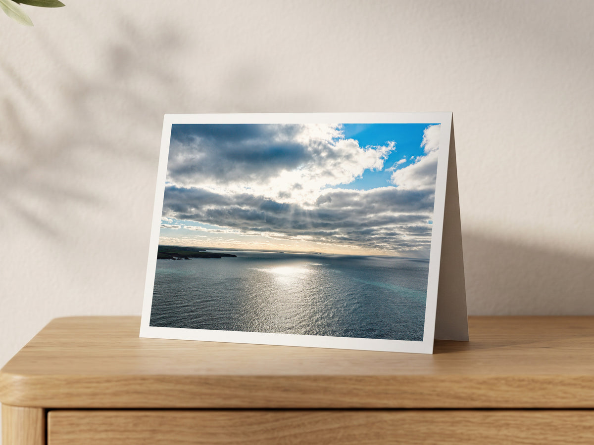 Premium A5 greeting card showing sunlight breaking through cloud onto the sea off Porthcothan