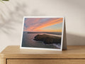 Premium A5 greeting card showing the Stepper Point Daymark beneath a red and gold winter sunrise