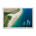 St George’s Cove fridge magnet showing three speedboats leaving wakes over deep blue water, pale shallows and golden sand