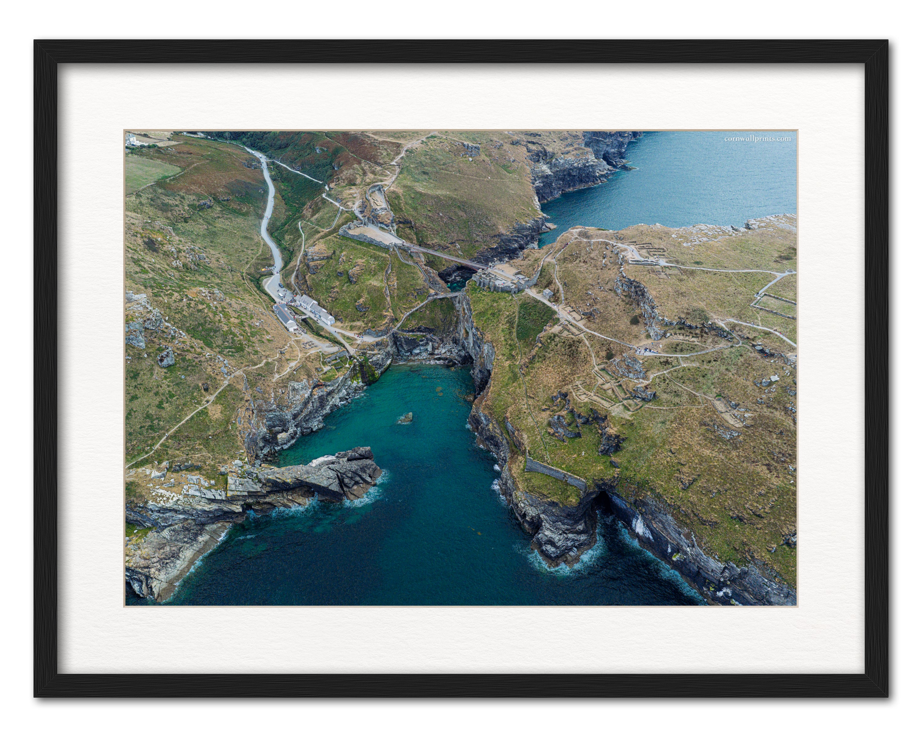 Tintagel Castle aerial photograph displayed in a black frame with white mount