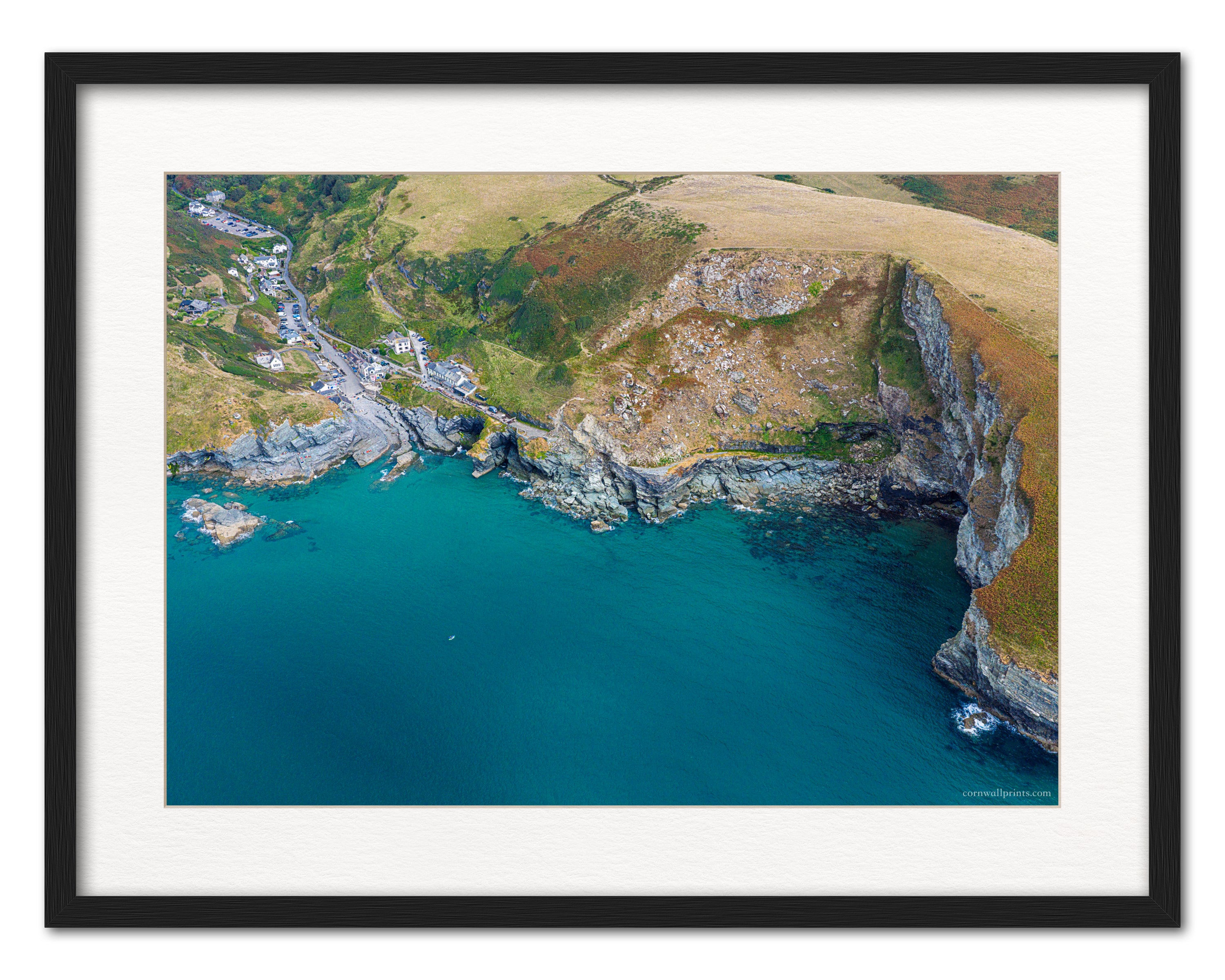 Trebarwith Strand aerial photograph displayed in a black frame with white mount