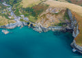 Aerial view of Trebarwith Strand, turquoise water and high North Cornwall cliffs