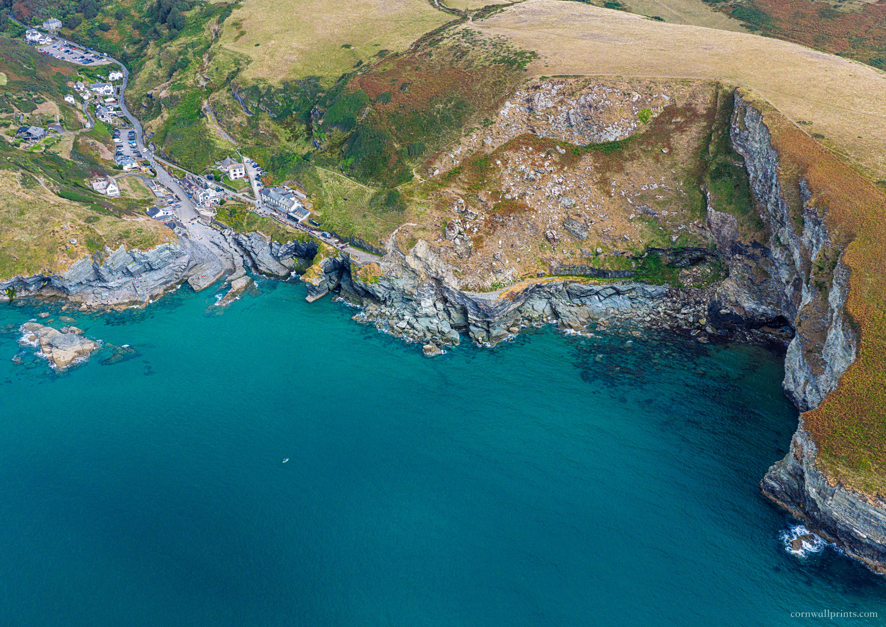Aerial view of Trebarwith Strand, turquoise water and high North Cornwall cliffs