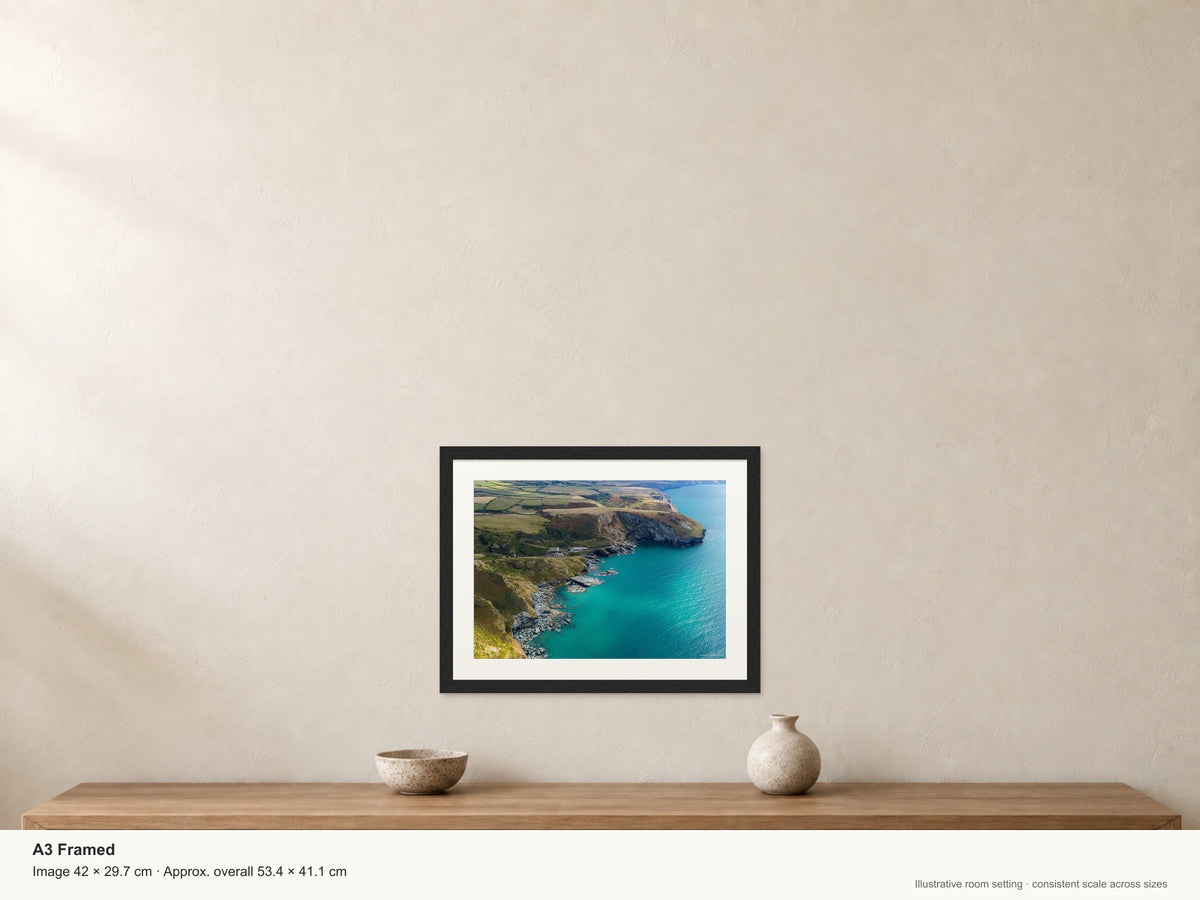 Trebarwith Strand — Turquoise Water and Clifftop Fields — A3 framed, 22mm black stained frame and 35mm mount. Illustrative room scale and dimensions.