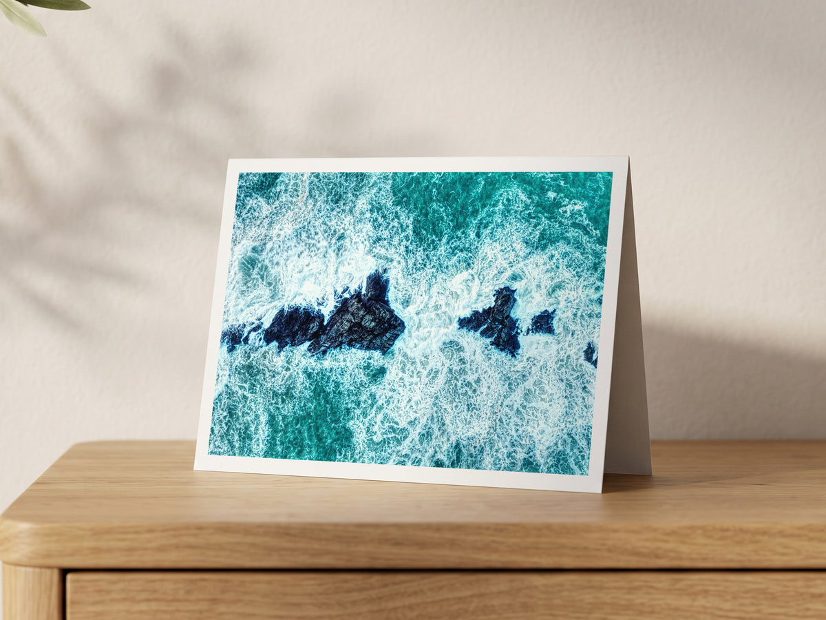 Premium A5 greeting card showing whitewater surging over the Trescore rocks in winter