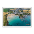 Fridge magnet showing Trevone Bay at high tide with turquoise water over the reef and the village beside the beach
