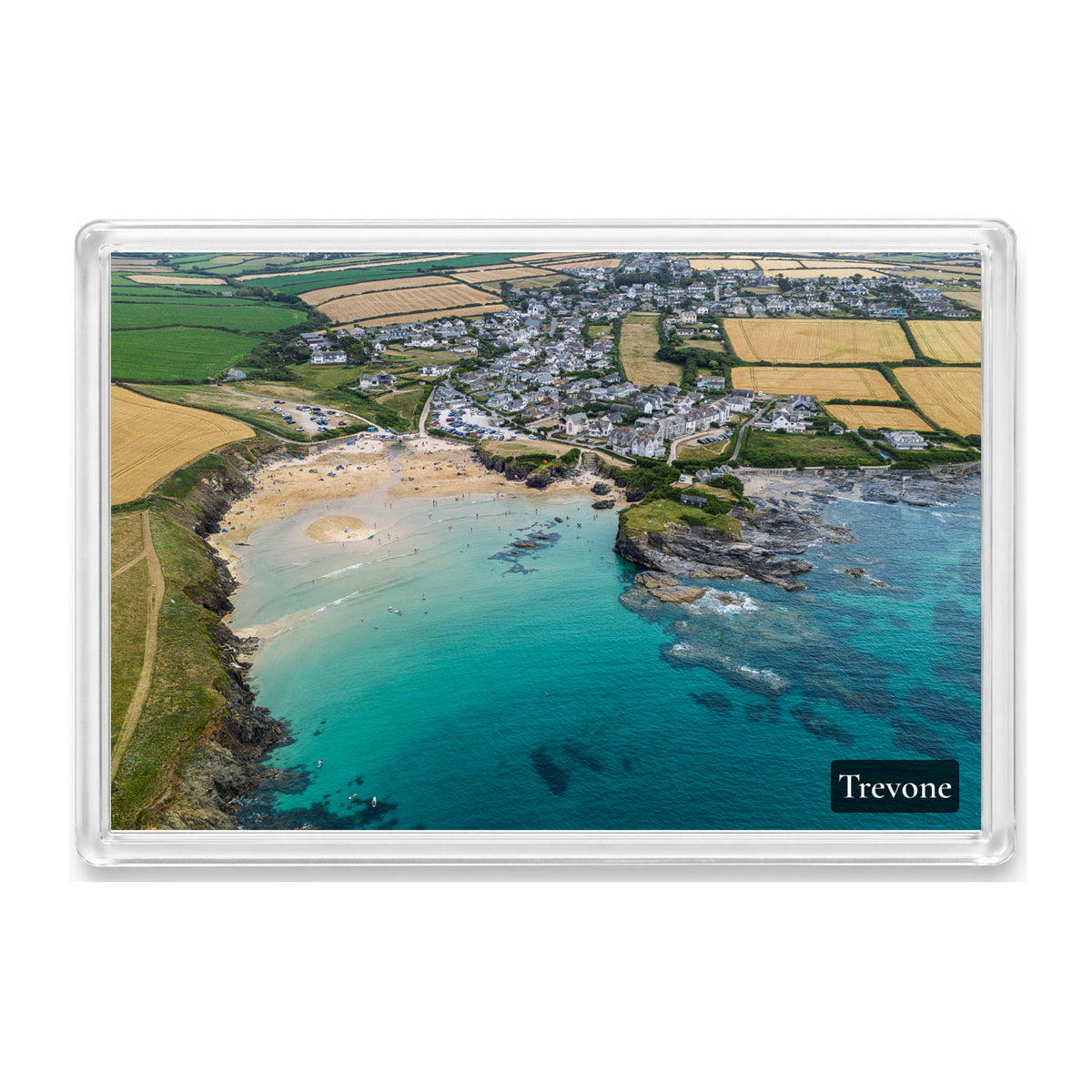 Fridge magnet showing Trevone Bay at high tide with turquoise water over the reef and the village beside the beach