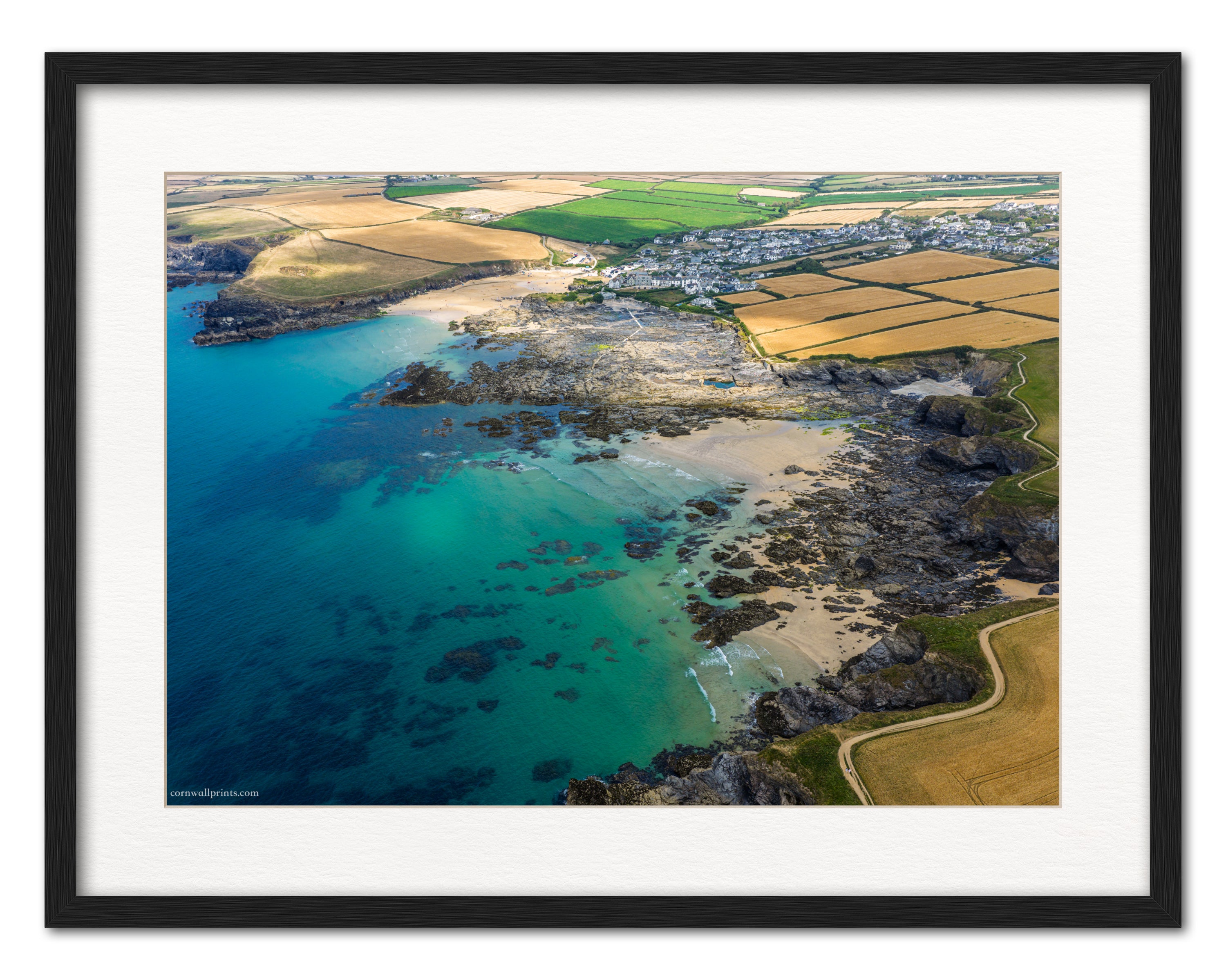Trevone Bay, Newtrain sea pool and Round Hole aerial photograph displayed in a black frame with white mount