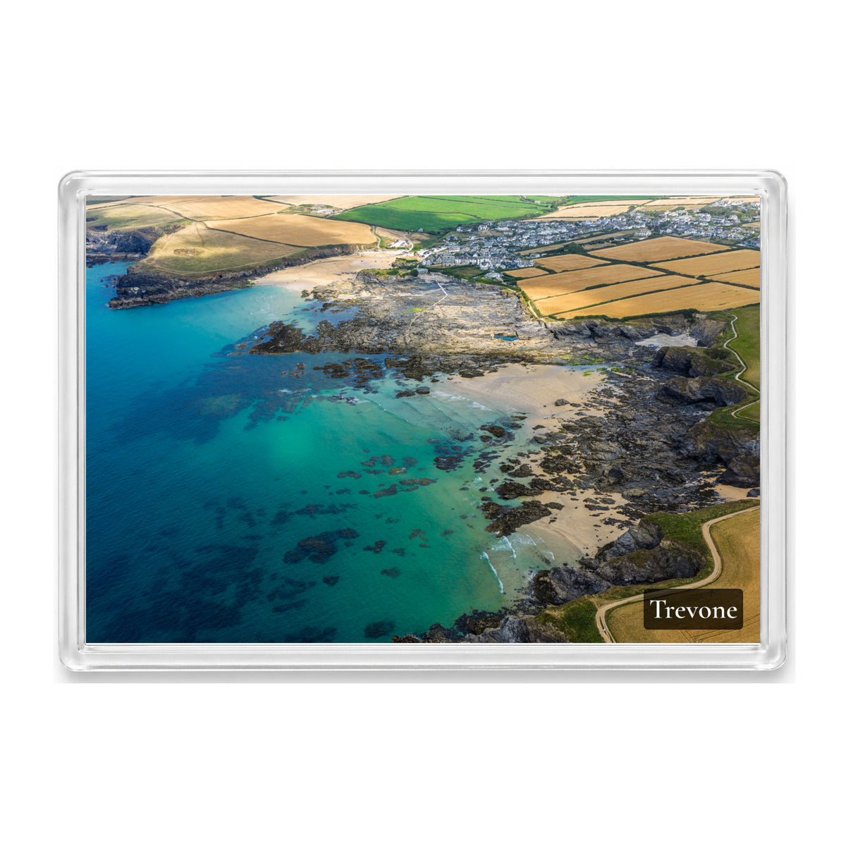 Trevone fridge magnet showing turquoise water past Newtrain Bay’s rock platforms towards the sea pool and Round Hole