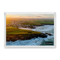 Trevone fridge magnet showing the dark circular Round Hole blowhole at sunrise with warm light across Trevone Bay